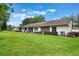 Expansive backyard showcasing the building's exterior and lush green landscaping. A peaceful retreat at 239 Hill St # 239, Casselberry, FL 32707