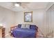 This bedroom features a daybed, ceiling fan, and ample closet space at 239 Hill St # 239, Casselberry, FL 32707