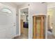 Inviting foyer showcasing hardwood floors, decorative doors, a glass display cabinet and bathroom access at 239 Hill St # 239, Casselberry, FL 32707