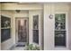 Inviting front entry with textured walls, decorative glass windows, and a secure storm door for added protection at 239 Hill St # 239, Casselberry, FL 32707