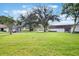 Spacious front yard with mature trees and lush green grass creating a welcoming landscape at 239 Hill St # 239, Casselberry, FL 32707