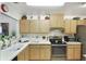The kitchen features modern stainless steel appliances, light wood cabinets, and lots of counter space at 239 Hill St # 239, Casselberry, FL 32707