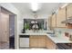 Bright kitchen features white appliances, double basin sink, and a pass-through to living area at 239 Hill St # 239, Casselberry, FL 32707