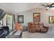 Cozy living room with a plush leather sofa, slider to deck, and vaulted ceilings at 239 Hill St # 239, Casselberry, FL 32707