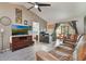 A comfortable living space with natural lighting, fan, tv, and a view into kitchen area at 239 Hill St # 239, Casselberry, FL 32707