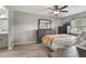 Spacious bedroom with a ceiling fan, wood-look floors and a view of the kitchen at 239 Hill St # 239, Casselberry, FL 32707