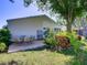 Charming backyard featuring an outdoor dining set, lush garden, and ample green space, perfect for relaxing at 25307 La Grange Ct, Leesburg, FL 34748