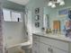Bathroom featuring a tub and shower combination plus a sleek vanity with ample counter space at 25307 La Grange Ct, Leesburg, FL 34748