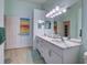 Bright bathroom with dual sinks, marble countertop vanity, and ample storage at 25307 La Grange Ct, Leesburg, FL 34748