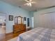 Light-filled bedroom featuring a dresser and ensuite bathroom access for a private retreat at 25307 La Grange Ct, Leesburg, FL 34748