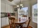 Cozy breakfast nook with wood table, stylish chairs, and lots of natural light from large windows at 25307 La Grange Ct, Leesburg, FL 34748