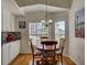 Cozy dining area with a round table, four chairs, and natural light from the windows at 25307 La Grange Ct, Leesburg, FL 34748