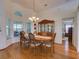 Elegant dining room featuring a classic chandelier, wood china cabinet, and natural light through large windows at 25307 La Grange Ct, Leesburg, FL 34748