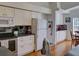 Well-lit kitchen with white cabinets, stainless steel appliances, and a breakfast nook nearby at 25307 La Grange Ct, Leesburg, FL 34748