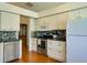 Well-equipped kitchen with stainless steel appliances, white cabinets, and a modern backsplash at 25307 La Grange Ct, Leesburg, FL 34748
