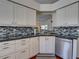 Bright kitchen with white cabinets, sleek countertops, and stainless steel appliances at 25307 La Grange Ct, Leesburg, FL 34748