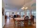 Spacious living area with a dining table, ceiling fan, hardwood floors, and lots of natural light at 25307 La Grange Ct, Leesburg, FL 34748