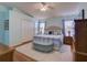Bright and airy main bedroom with hardwood floors, ceiling fan, and lots of natural light from the windows at 25307 La Grange Ct, Leesburg, FL 34748