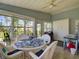 Bright sunroom with ample windows, comfortable seating, and views of the serene outdoors at 25307 La Grange Ct, Leesburg, FL 34748