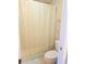 This bathroom features a shower-tub combo with neutral tiling and a bright shower curtain at 2812 Club Cortile Cir # A, Kissimmee, FL 34746