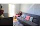 Bright bedroom with a futon, chair, and desk perfect for relaxing and working at 2812 Club Cortile Cir # A, Kissimmee, FL 34746