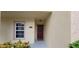 Inviting townhome entrance with a red front door and well-maintained landscaping at 2812 Club Cortile Cir # A, Kissimmee, FL 34746