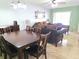 Open-concept living area with dining table, comfortable seating, and natural light at 2812 Club Cortile Cir # A, Kissimmee, FL 34746