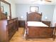 Well-appointed main bedroom featuring a decorative wood bed frame, matching dresser, and bedside tables at 2812 Club Cortile Cir # A, Kissimmee, FL 34746