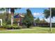 Community playground surrounded by lush greenery and palms trees at 2812 Club Cortile Cir # A, Kissimmee, FL 34746