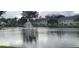 Scenic view of a pond with a fountain, reflecting the surrounding buildings and trees at 2812 Club Cortile Cir # A, Kissimmee, FL 34746