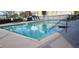 A large community pool with plenty of lounge chairs for relaxing by the water at 2812 Club Cortile Cir # A, Kissimmee, FL 34746