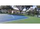 Community blue and green tennis court with view of the lake at 2812 Club Cortile Cir # A, Kissimmee, FL 34746