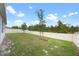 A spacious backyard featuring a well-maintained lawn and a secure white fence at 2900 Sunridge Loop, St Cloud, FL 34771