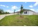 A spacious backyard featuring a well-maintained lawn and a secure white fence at 2900 Sunridge Loop, St Cloud, FL 34771