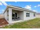 Exterior view of backyard featuring an outdoor patio, green grass and a fence at 2900 Sunridge Loop, St Cloud, FL 34771