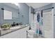 Well-lit bathroom featuring blue walls, a shower-tub combo and modern fixtures at 2900 Sunridge Loop, St Cloud, FL 34771