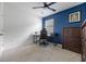 Comfortable bedroom with a blue accent wall, and desk with office chair at 2900 Sunridge Loop, St Cloud, FL 34771