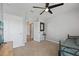 Neutral bedroom featuring a ceiling fan, carpet and a view to a hallway at 2900 Sunridge Loop, St Cloud, FL 34771