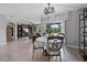 Open-concept living and dining area with a table for four, tile floor, and entertainment center at 2900 Sunridge Loop, St Cloud, FL 34771