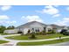 Well-manicured lawn, driveway, and landscaping of this single-story home at 2900 Sunridge Loop, St Cloud, FL 34771