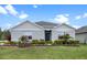 Charming single-story home with well-manicured lawn, landscaping, and blue front door with decorative wreath at 2900 Sunridge Loop, St Cloud, FL 34771
