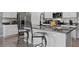 Kitchen island features an undermount sink, granite countertop, and bar stool seating at 2900 Sunridge Loop, St Cloud, FL 34771