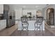 Well-lit kitchen with stainless steel appliances, island seating, and granite countertops at 2900 Sunridge Loop, St Cloud, FL 34771