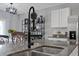 Kitchen island with stainless steel undermount sink, stylish faucet, and decorative shelving at 2900 Sunridge Loop, St Cloud, FL 34771
