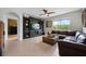 Inviting living room features a large window, ceiling fan, and stylish entertainment center at 2900 Sunridge Loop, St Cloud, FL 34771