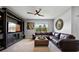 Comfortable living room featuring a sectional sofa, ceiling fan, and natural light at 2900 Sunridge Loop, St Cloud, FL 34771