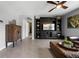 Well-lit living room features a ceiling fan, stylish furniture, and an entertainment center at 2900 Sunridge Loop, St Cloud, FL 34771