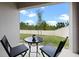 Outdoor patio features a small table with seating, and views to the green yard at 2900 Sunridge Loop, St Cloud, FL 34771