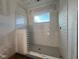 Under-construction walk-in shower featuring white subway tile and a window at 2980 Embark Trail, St Cloud, FL 34771