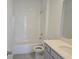 Bright bathroom featuring white tiling, new sink, and a shower-tub combination at 2980 Embark Trail, St Cloud, FL 34771